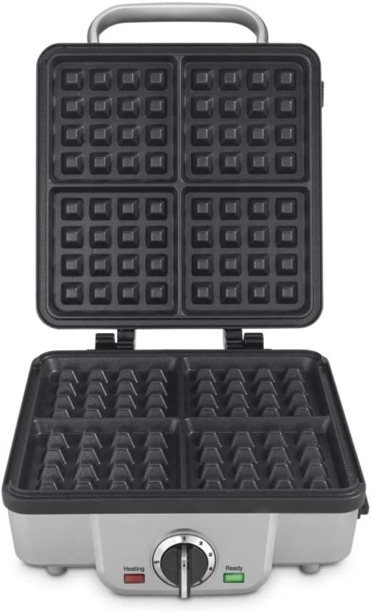 Golden Belgian waffles beside a stainless steel waffle maker