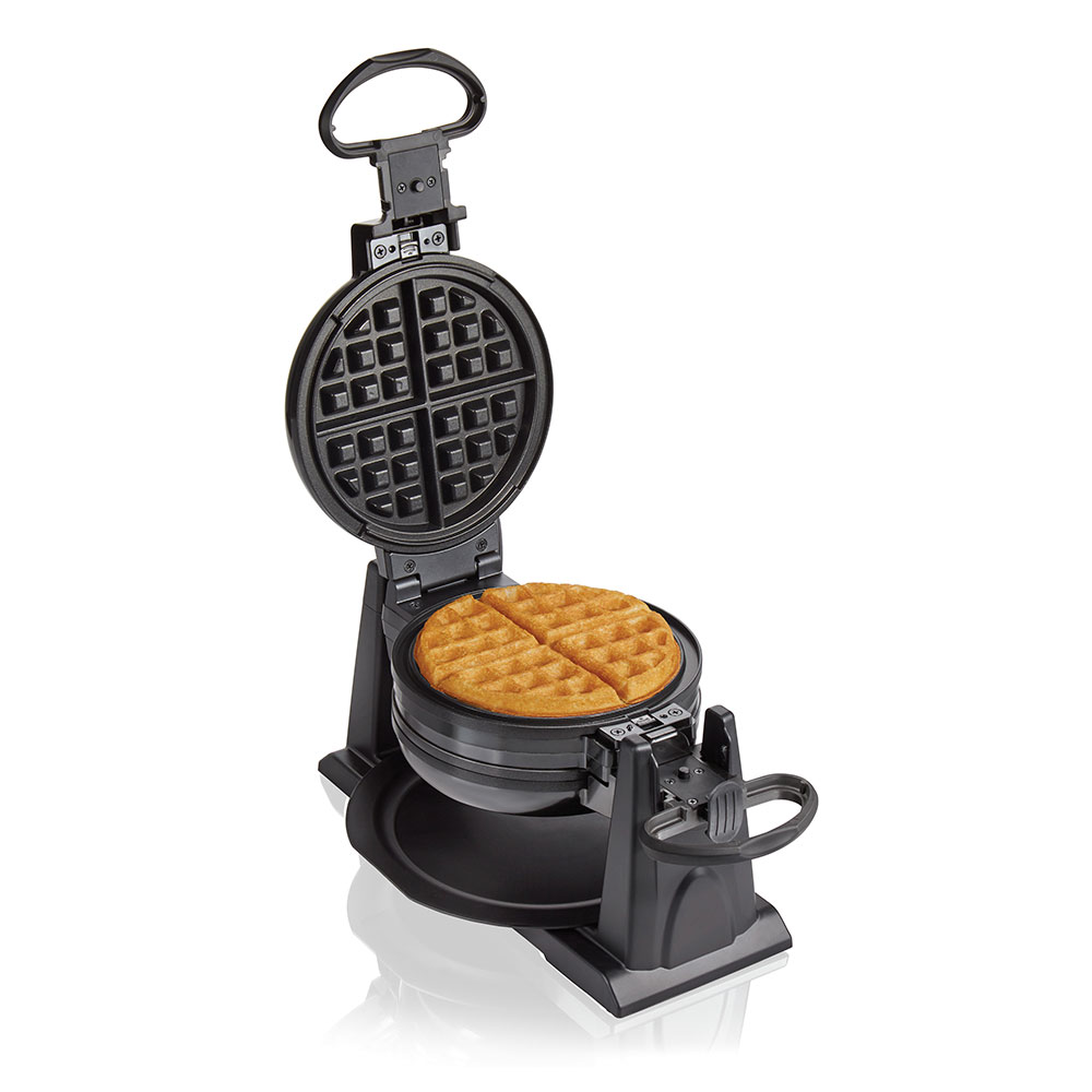 Golden Belgian waffles beside a stainless steel waffle maker