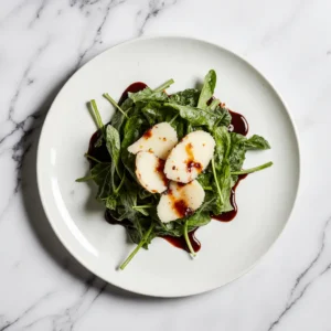 Fresh arugula salad with shaved Parmesan and creamy balsamic dressing.